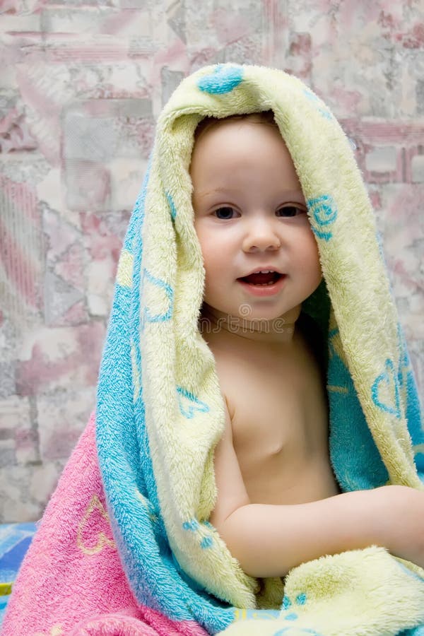 Baby after bath under towel