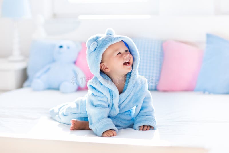 Baby in bathrobe or towel after bath
