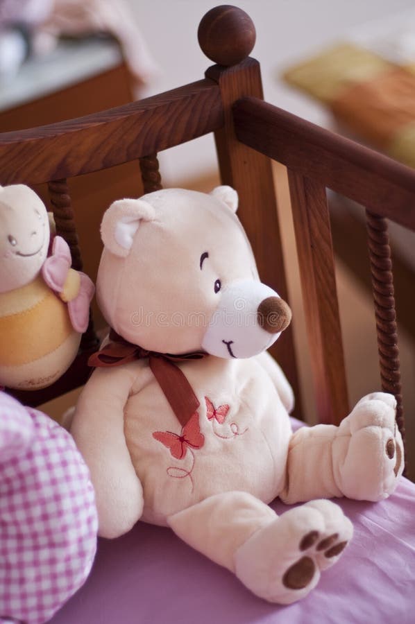 Baby bed with teddy bear. And others toys stock photo