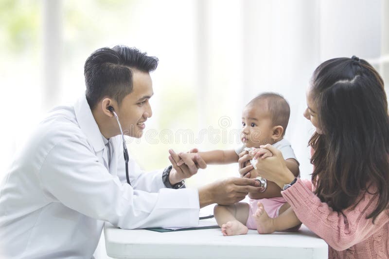 baby being checked by a doctor stock photos baby being checked by a doctor stock photos