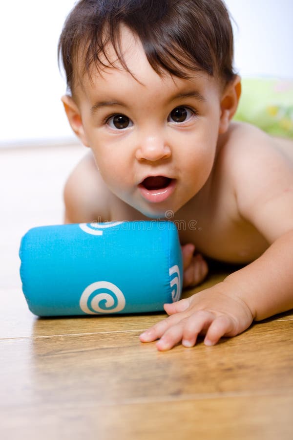 Cute 8 months old baby belly-band on hardwood floor. Lovely european female stock images, royalty-free photos and pictures