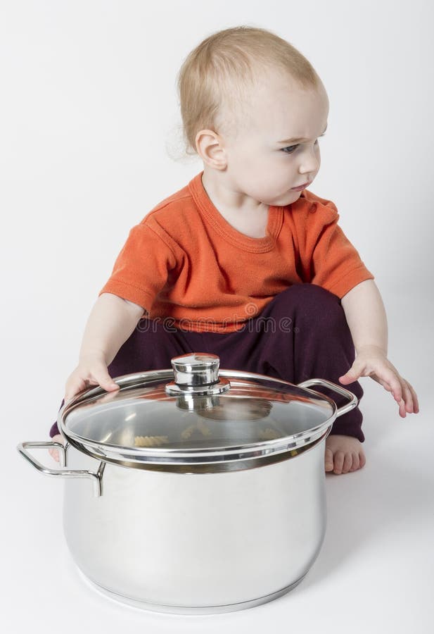 baby with big cooking pot Stock Photo