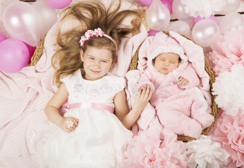Baby birthday party gifts. Girl holding newborn sister hand. Chi stock image Baby birthday party gifts. Girl holding newborn sister hand. Chi stock image
