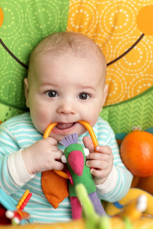 Baby biting rattle stock photo. Image of childhood, life 23894312