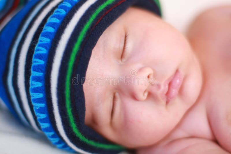 Baby in blue cap sleeping stock photo. Image of caucasian ...