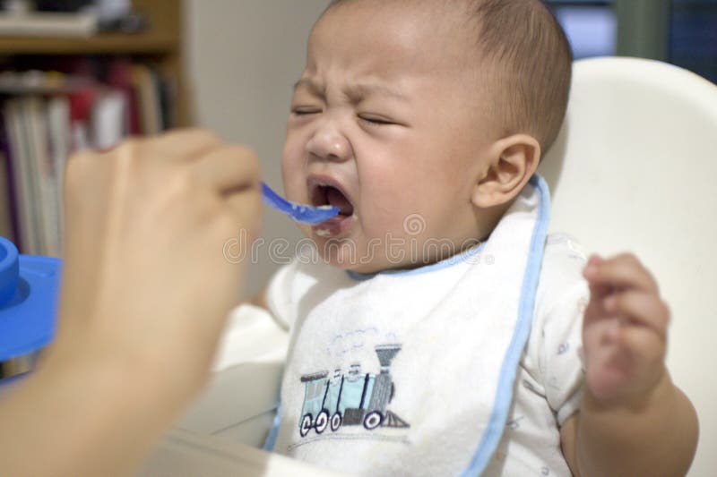 A baby boy is being fed by his mother royalty free stock photography A baby boy is being fed by his mother royalty free stock photography