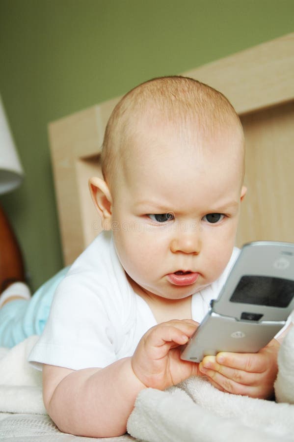 Baby boy with a cellphone stock image. Image of cute, baby 6044137