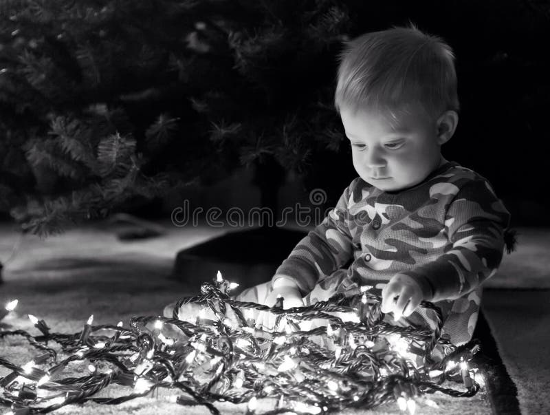 Baby boy with Christmas lights