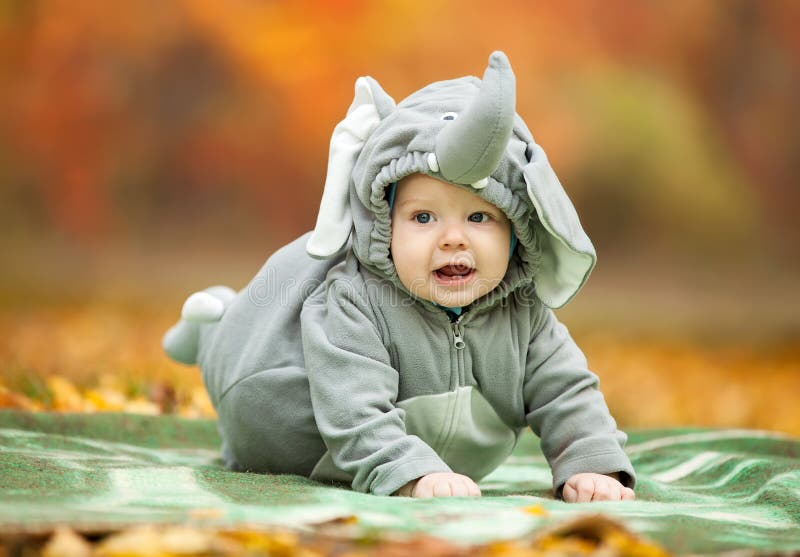 Baby boy dressed in elephant costume in park