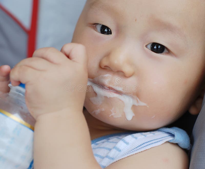 Baby boy eating acidophilus milk