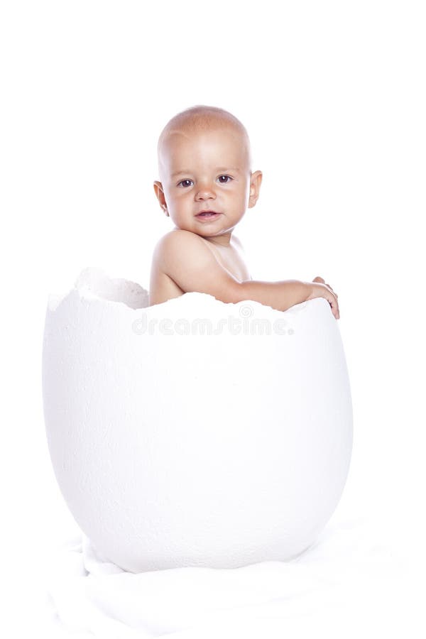Baby boy in egg on white