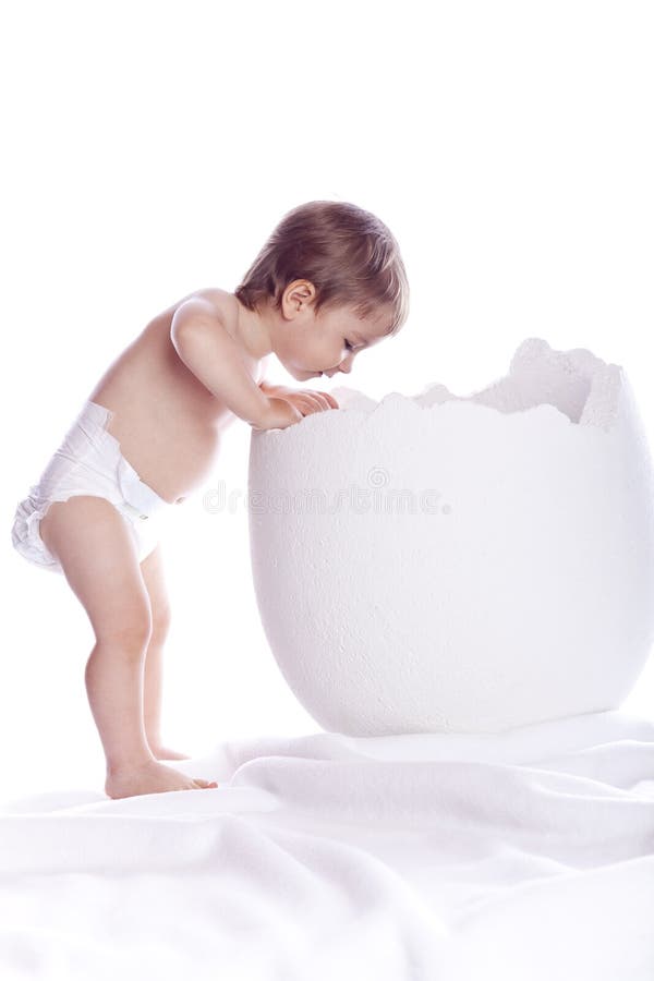 Baby boy with egg on white