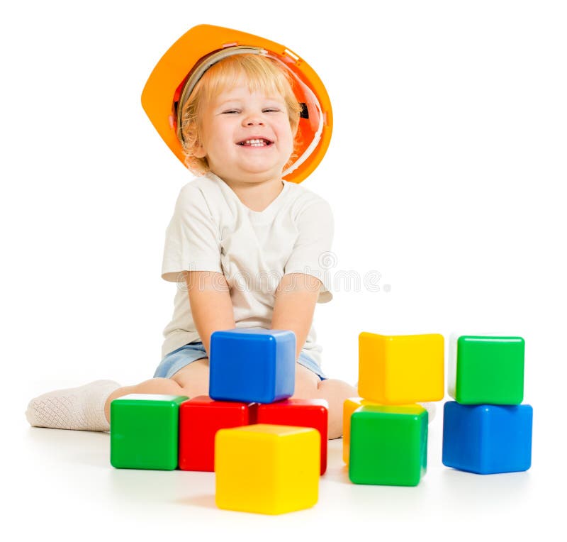 Baby boy in hard hat playing colorful building blocks royalty free stock photography