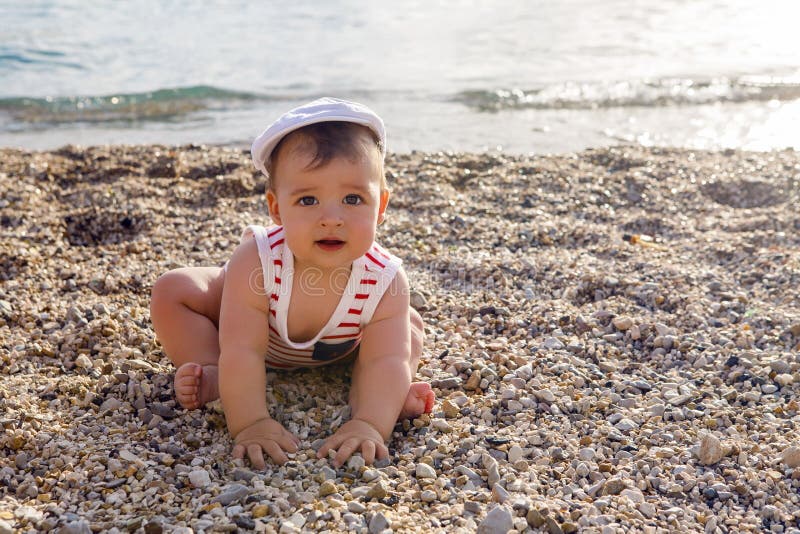 Baby Boy in Hat on Beach Pebbles Stock Image Image of child, ocean