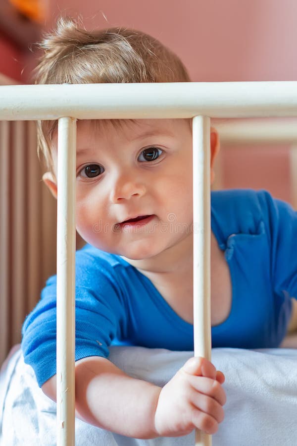 Baby boy in his crib stock image. Image of interior 142731371