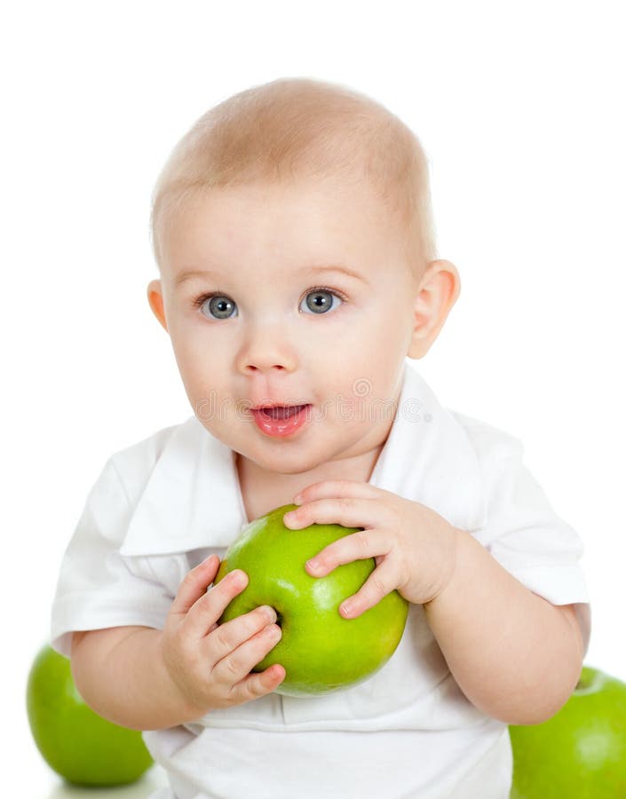 Baby boy holding and eating green apple