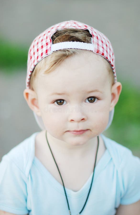 Baby boy in a plaid cap stock image. Image of macho, hoodlum 92451985