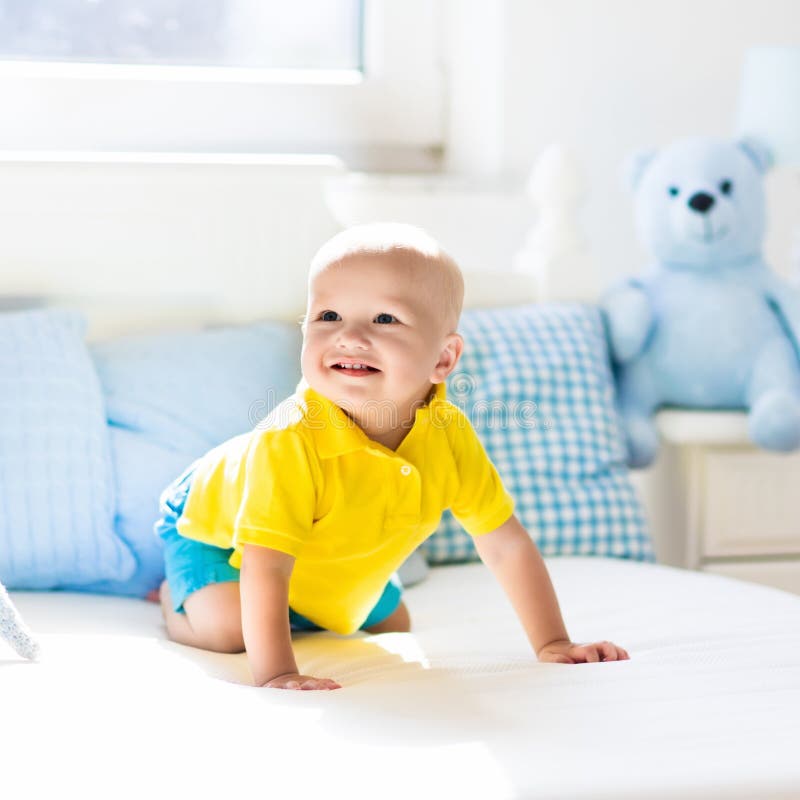 Baby Boy Playing on Bed in Sunny Nursery Stock Image - Image of child ...