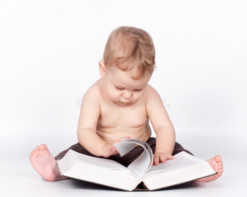 Baby boy playing with book on white royalty free stock photography