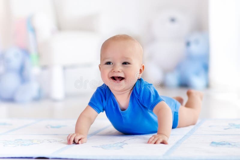 Baby boy playing and learning to crawl