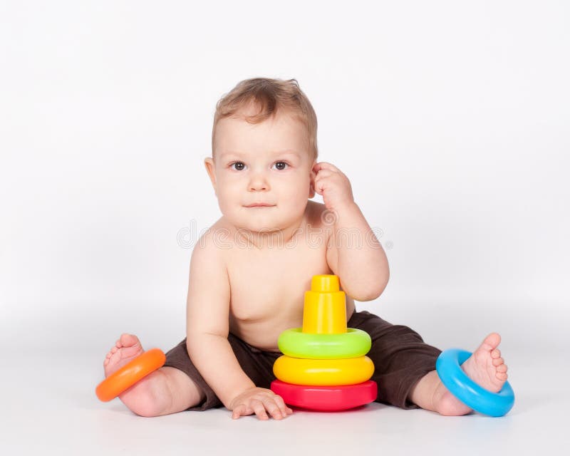 Baby boy playing with toy pyramid on white royalty free stock images Baby boy playing with toy pyramid on white royalty free stock images