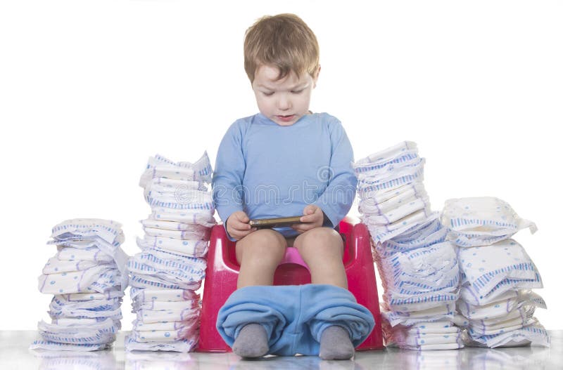 Baby boy sitting on chamber pot with smartphone and toilet paper