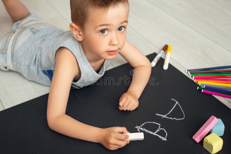 Baby boy studying at home. Happy child on the floor learns the alphabet