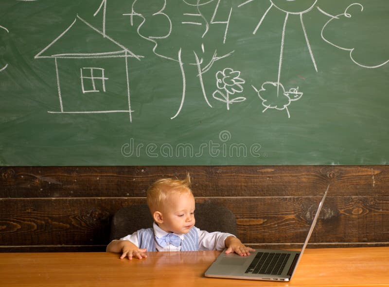 Baby boy use digital access in computer class. Developing digital literacy skills with network devices and internet stock photos