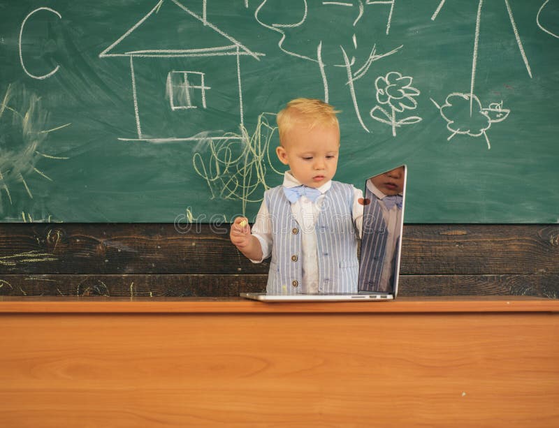 Baby boy use wireless internet in computer class. Developing digital literacy skills with wireless network devices in royalty free stock image