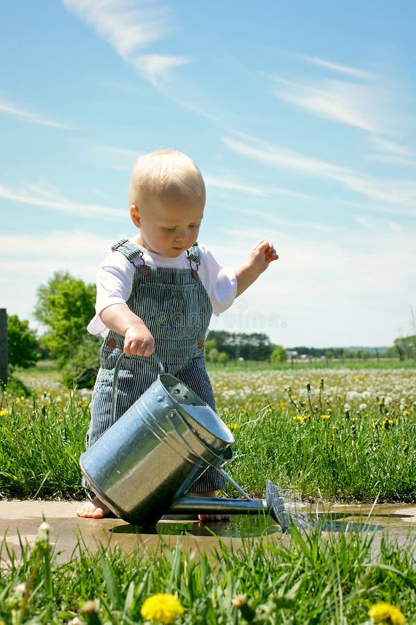 Baby Boy with Watering Can stock photo. Image of conductor 31296498