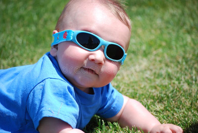 Baby Boy Wearing Sunglasses Laying On Grass Royalty Free Stock Images