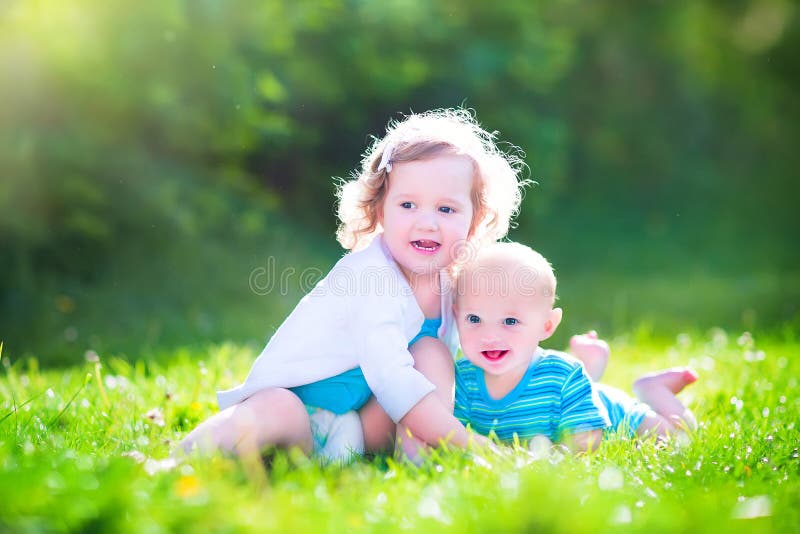 Baby Brother and Toddler Sister in a Garden Stock Photo - Image of ...