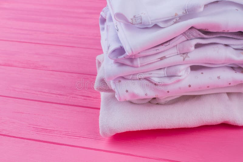 Baby clothes on pink wood. stock photo. Image of cropped - 130014054