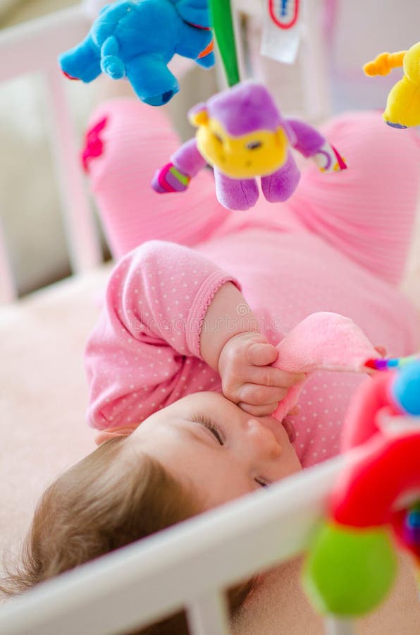 Baby in a cot stock image. Image of home, caucasian, fence 76672697