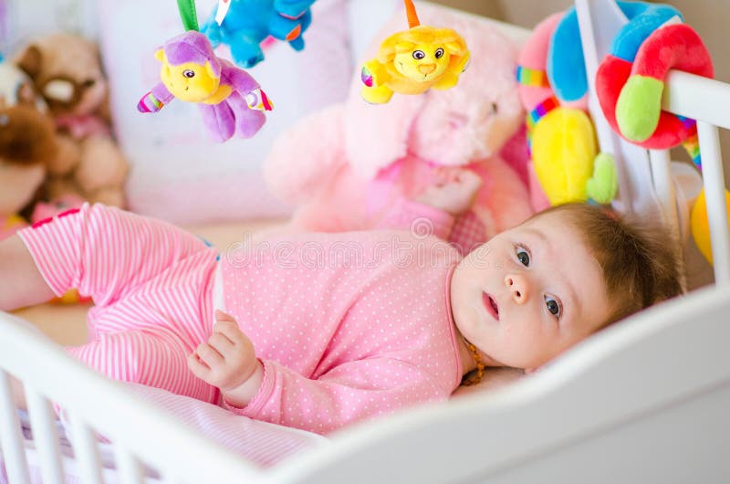 Baby in a cot stock photo. Image of bedroom, colorful 76672756