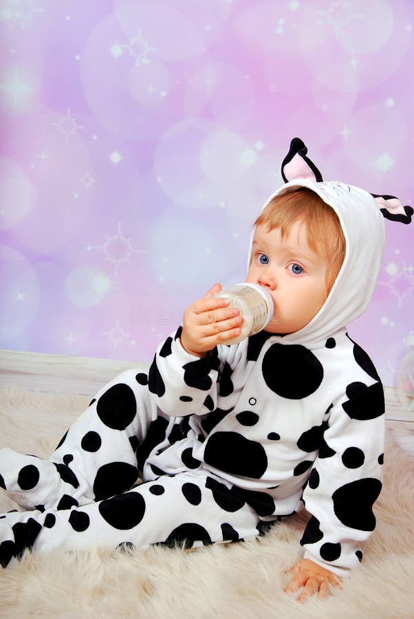 Baby In Cow Costume Drinking Milk From Bottle Stock Photos ...