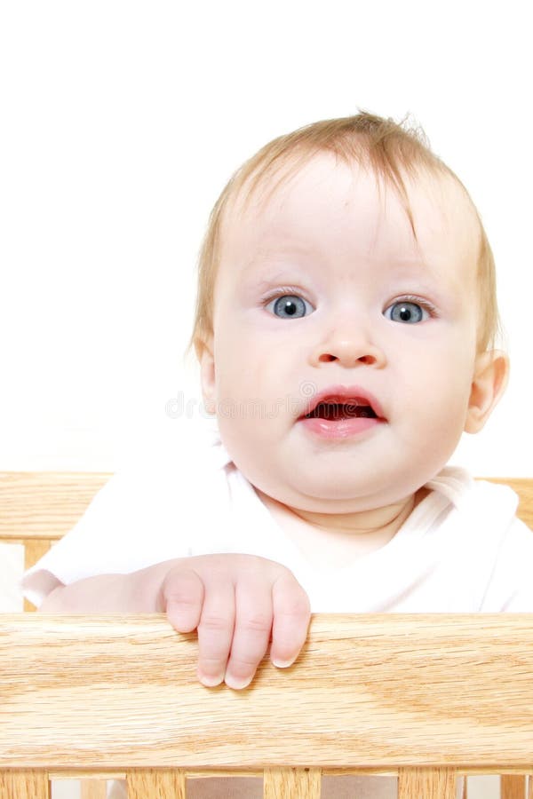 Baby Standing in Crib stock image. Image of mouth, face 2052789