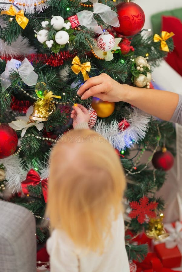 Baby Decorating Christmas Tree. Rear View Stock Photo Image of
