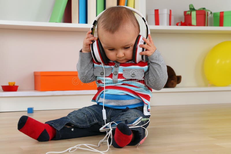 Portrait of a baby listening to music with headphones. Portrait of a baby listening to music with headphones