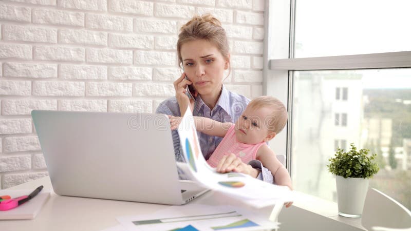 Baby distracted mother from conversation. Modern woman working from home