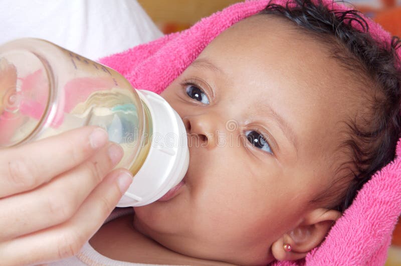 Baby drinking a bottle stock photography