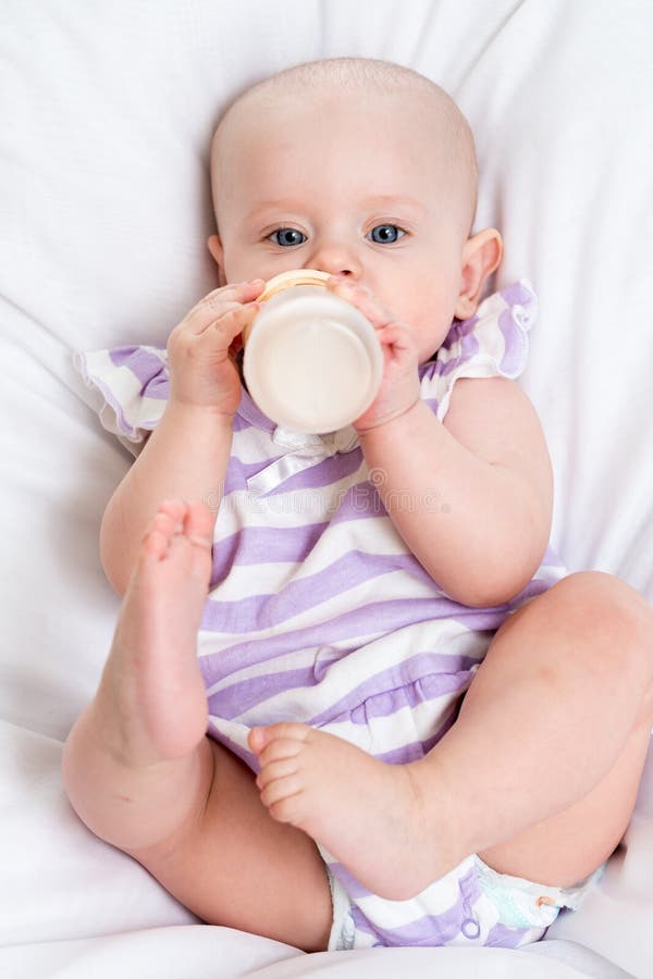 Baby Drinking Milk from Bottle Stock Photo Image of lying