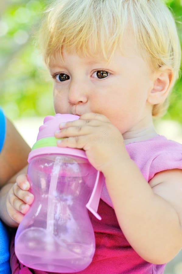 Baby drinking water stock photo. Image of hand, blue 35681944