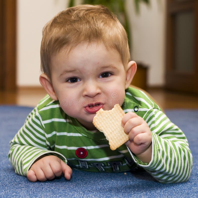 Baby eating a biscuit