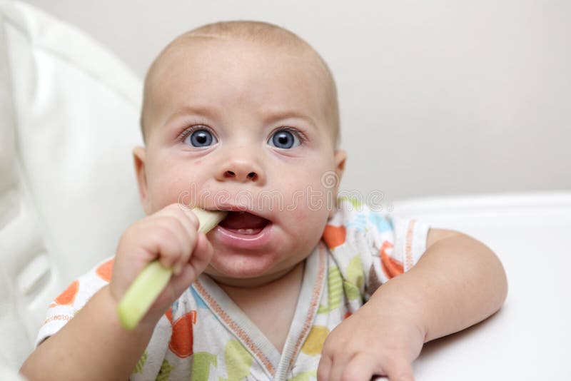 Baby eating with spoon stock image. Image of face, meal 24010145