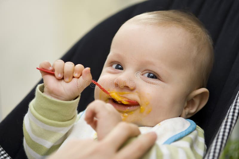 Baby eating with spoon