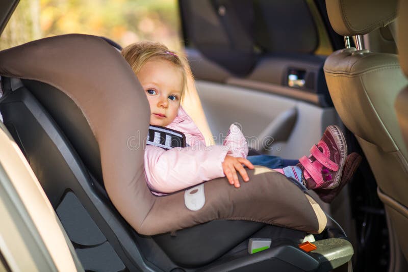 Baby fastened in car seat