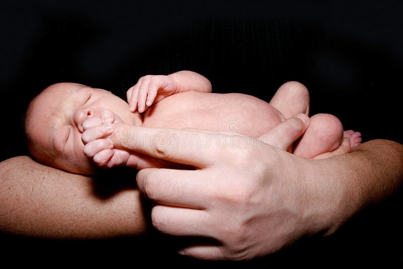 Baby on father's hands