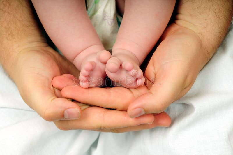 Baby feet in dads hand