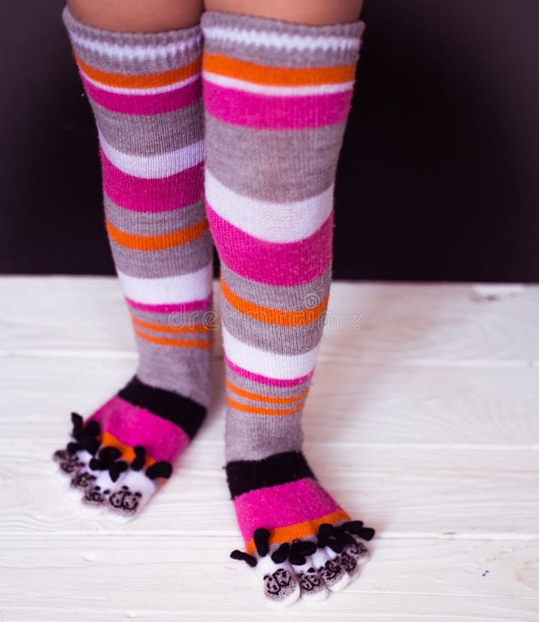 Baby Feet in Warm, Long Multicolored Socks with Toes Stock Image